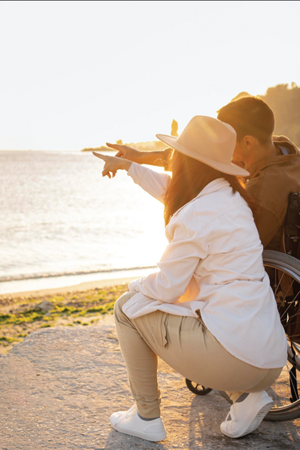 Couple sitting together and watching the sunset by the water