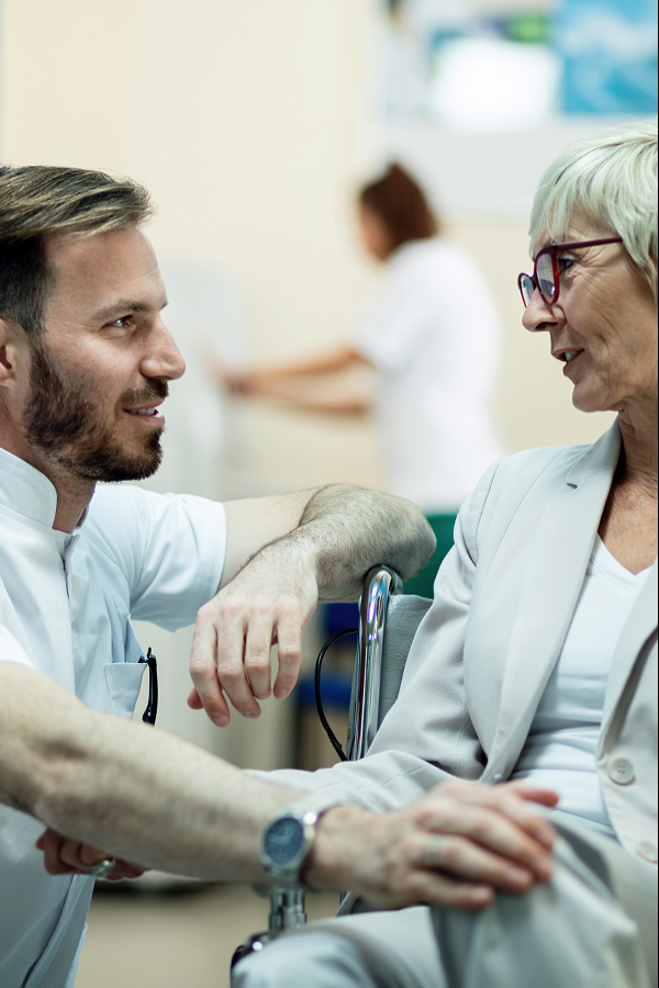 Smiling senior woman sitting in a wheelchair outdoors
