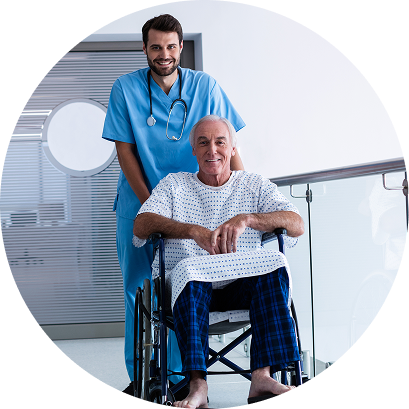 Smiling doctor standing behind an older male patient sitting in a wheelchair in a hospital